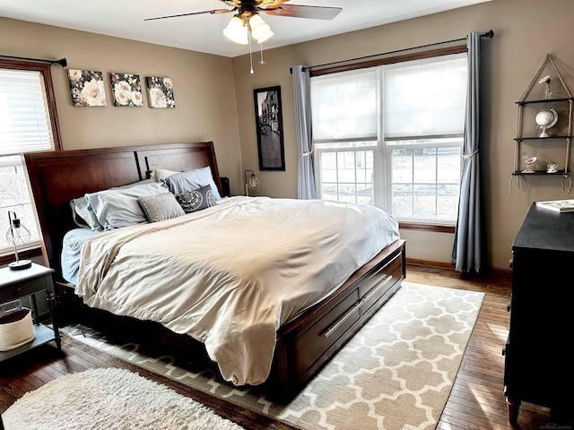 bedroom with baseboards, ceiling fan, and hardwood / wood-style floors