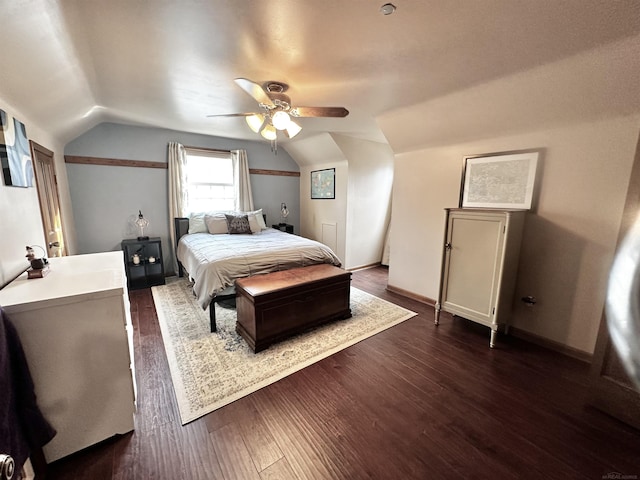 bedroom featuring ceiling fan, baseboards, lofted ceiling, and dark wood finished floors