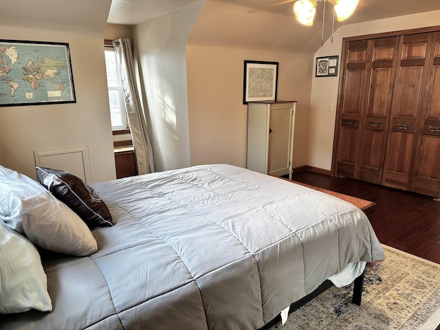 bedroom featuring dark wood finished floors, a closet, and baseboards