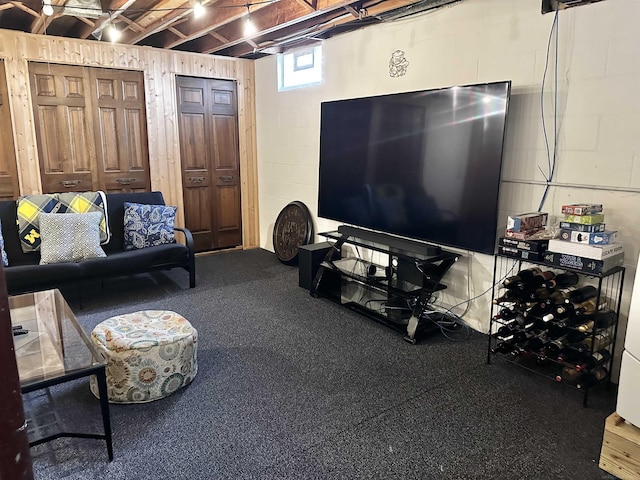 living area with concrete block wall