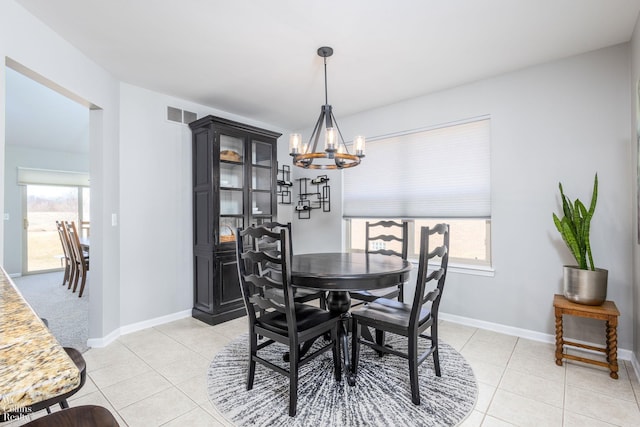 dining area featuring visible vents, a notable chandelier, a healthy amount of sunlight, and light tile patterned flooring