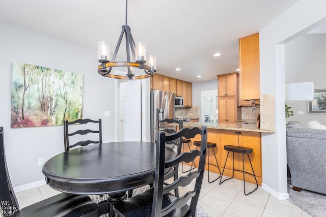 dining area featuring light tile patterned floors, recessed lighting, baseboards, and an inviting chandelier