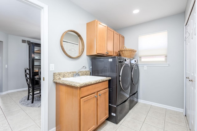 laundry room with light tile patterned floors, baseboards, independent washer and dryer, and a sink