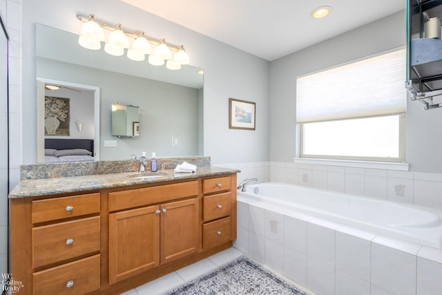 bathroom with tile patterned floors, connected bathroom, vanity, and a bath