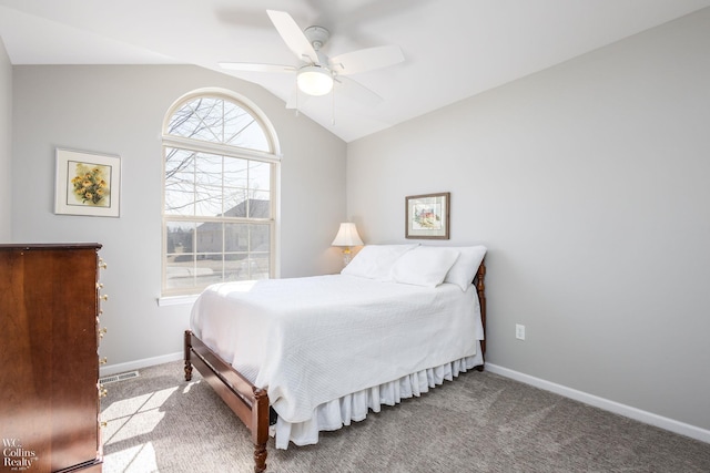 bedroom featuring lofted ceiling, baseboards, carpet floors, and ceiling fan