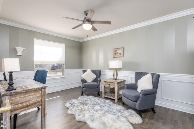 office space with a ceiling fan, crown molding, wood finished floors, and a wainscoted wall