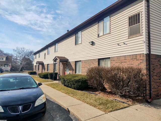 view of property exterior featuring brick siding