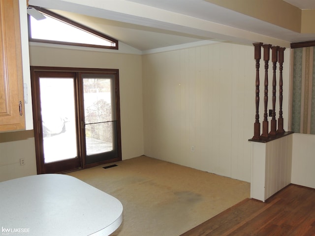 interior space featuring lofted ceiling, wood finished floors, and visible vents