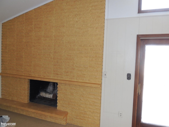 interior details with wainscoting and a brick fireplace