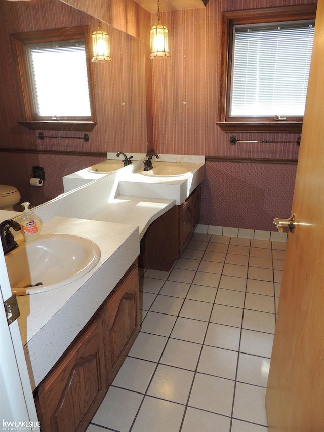 full bathroom with wallpapered walls, tile patterned floors, and vanity