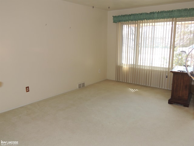 empty room with carpet flooring and visible vents