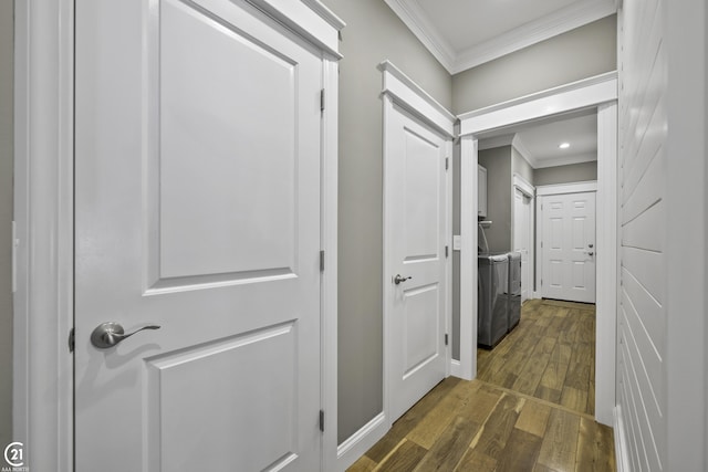 hall with a barn door, ornamental molding, recessed lighting, separate washer and dryer, and dark wood-style flooring