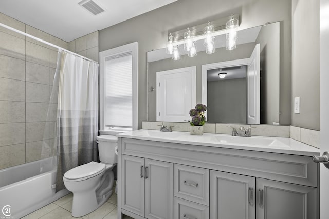 bathroom with tile patterned floors, visible vents, toilet, and a sink