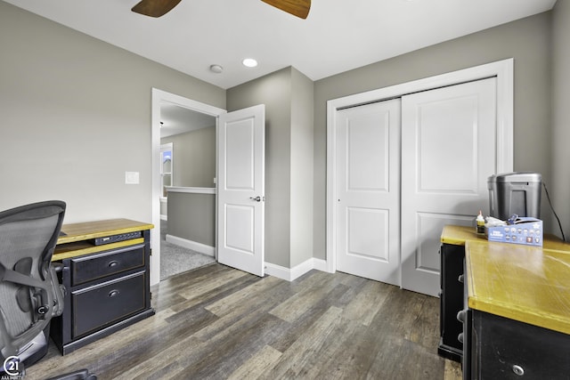 office space with baseboards, a ceiling fan, and dark wood-style flooring