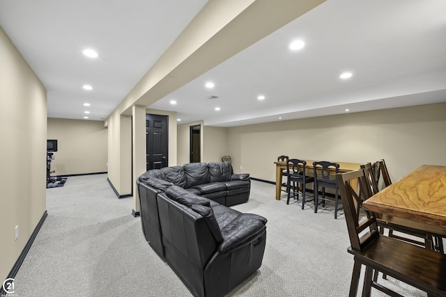 living room with recessed lighting, light colored carpet, and baseboards