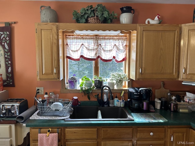 kitchen with dark countertops and a sink