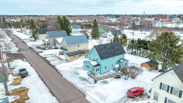 snowy aerial view with a residential view