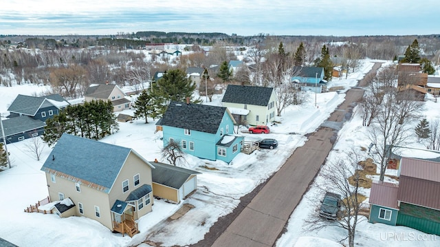 snowy aerial view with a residential view