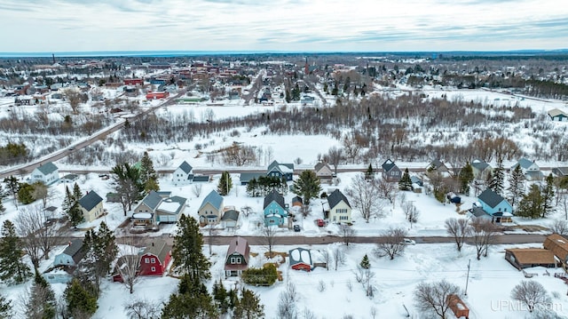 snowy aerial view with a residential view