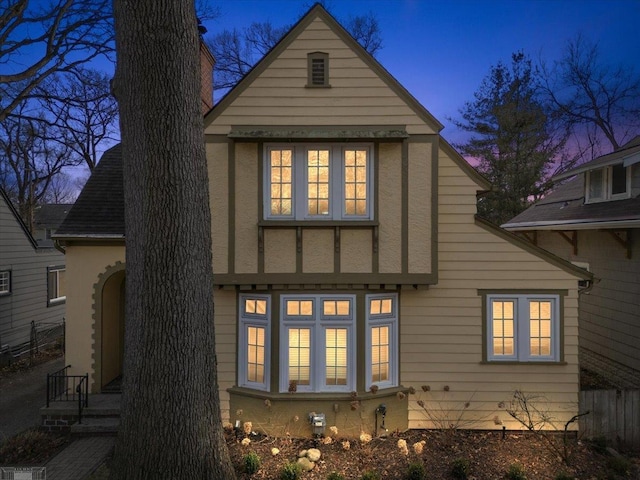 rear view of house with stucco siding