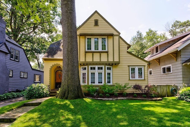 tudor home with a front yard