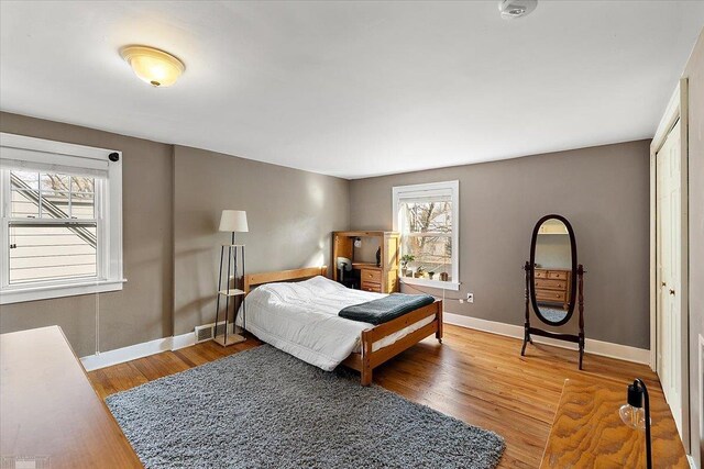 bedroom with baseboards and wood finished floors