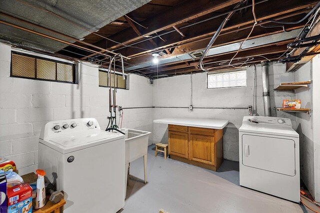 laundry room featuring a sink, cabinet space, and separate washer and dryer