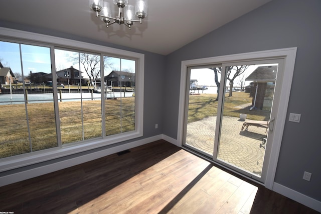 dining area featuring lofted ceiling, wood finished floors, and a wealth of natural light