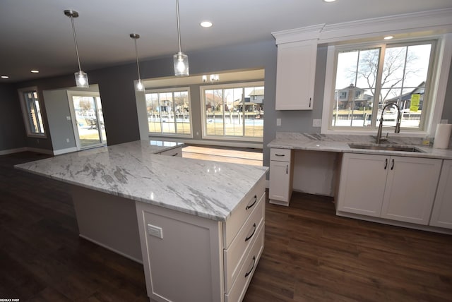 kitchen with a sink, dark wood-type flooring, recessed lighting, and white cabinetry