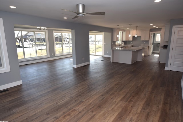 kitchen featuring recessed lighting, open floor plan, and white cabinets