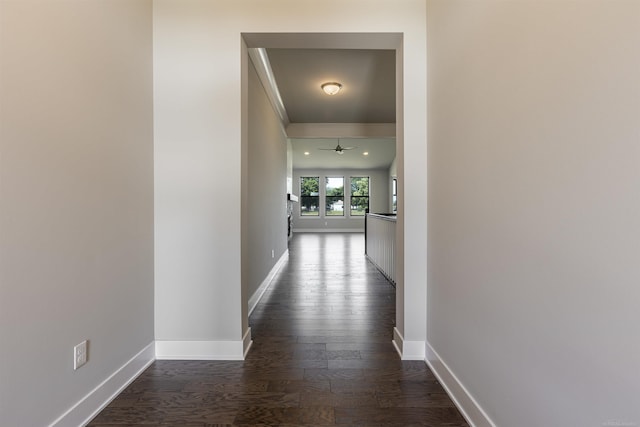 hall featuring baseboards and dark wood-style floors