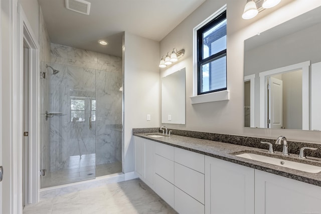 bathroom featuring a marble finish shower, visible vents, marble finish floor, and a sink