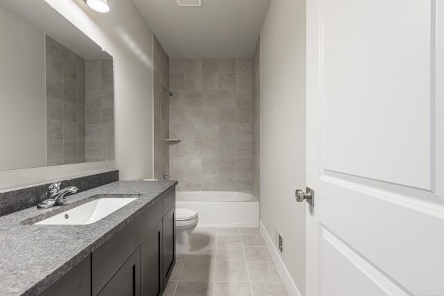 bathroom featuring baseboards, toilet, shower / bathtub combination, tile patterned floors, and vanity