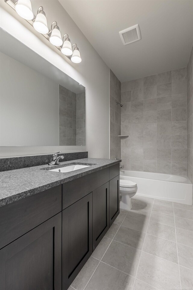 bathroom featuring visible vents, toilet, shower / bathing tub combination, tile patterned flooring, and vanity