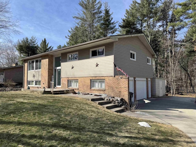 view of front of house featuring a front lawn, a garage, brick siding, and driveway