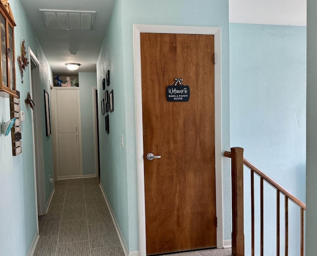 hallway featuring visible vents and baseboards