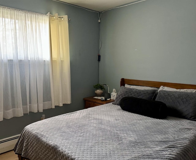 bedroom featuring a baseboard heating unit