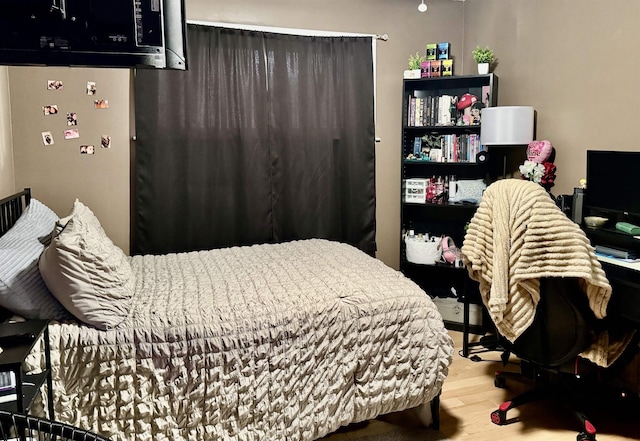 bedroom with wood finished floors