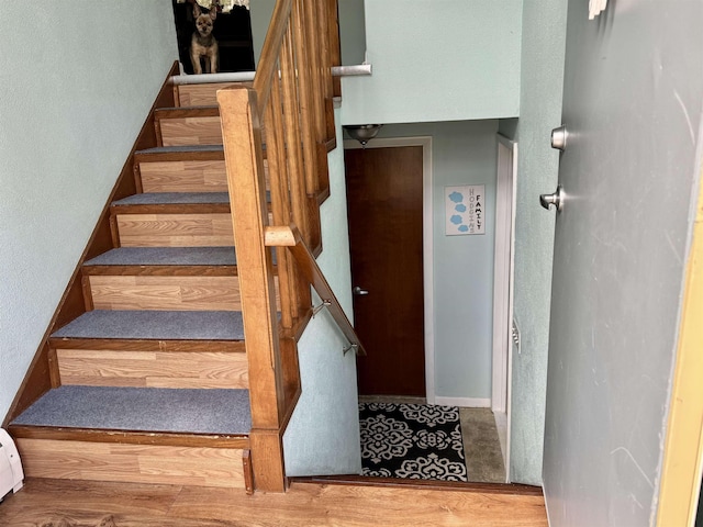 stairway with wood finished floors