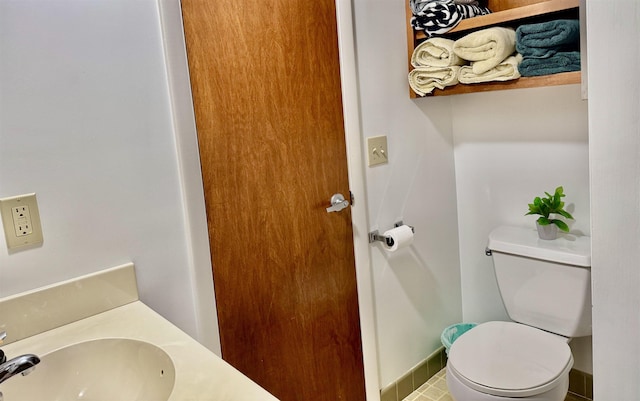 bathroom featuring toilet and a sink