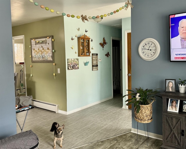 hallway with wood tiled floor, baseboards, and a baseboard radiator