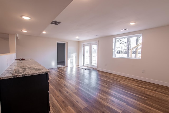 living room with recessed lighting, visible vents, dark wood-type flooring, and french doors