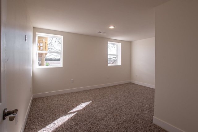 unfurnished room featuring visible vents, baseboards, and carpet floors