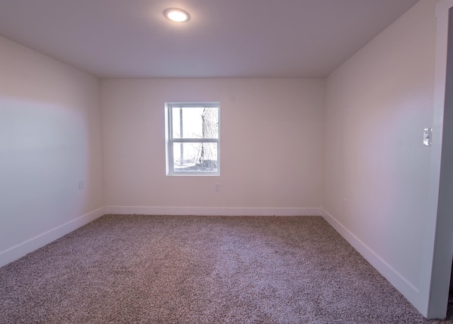 carpeted empty room with baseboards