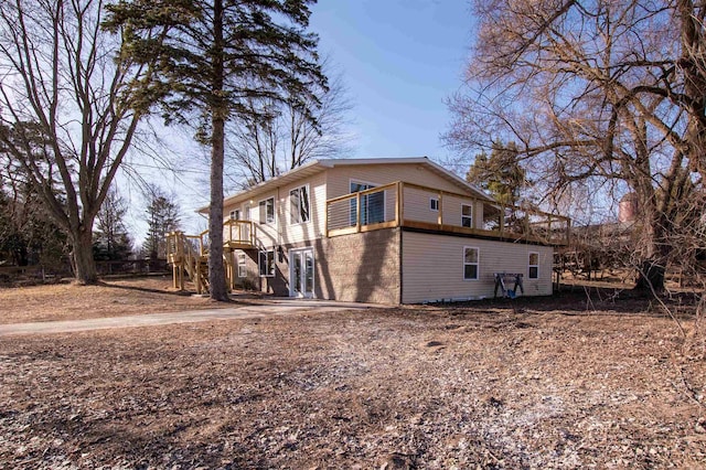 view of side of property featuring a wooden deck