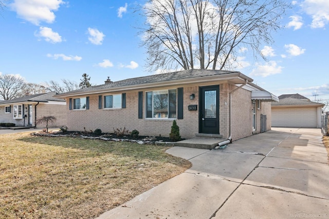 ranch-style house with an outbuilding, a front yard, a garage, brick siding, and a chimney