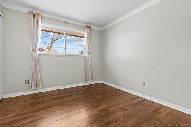 unfurnished room featuring wood finished floors and baseboards