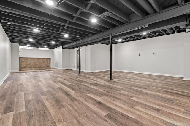 finished basement featuring baseboards and wood finished floors