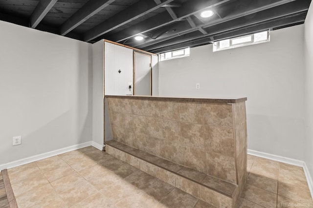 bar with tile patterned flooring and baseboards