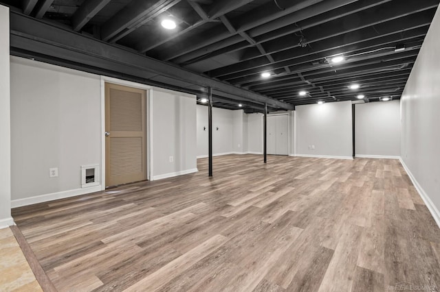 finished basement with wood finished floors and baseboards